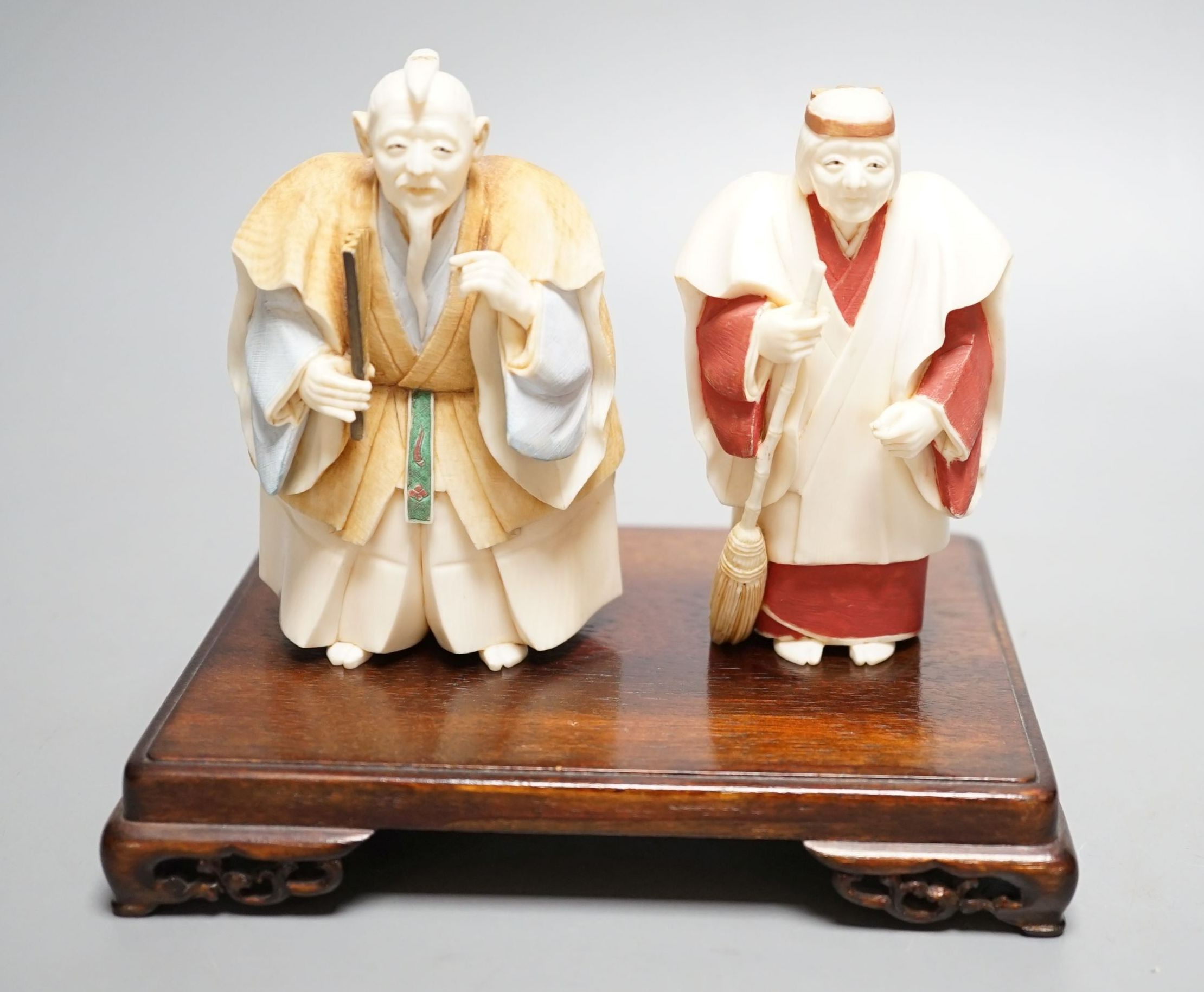 Two Japanese stained ivory figures of court servants, Taisho/early Showa period, signed - tallest 11cm